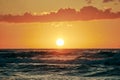 Yellow warm Sun over sea waves at scenic sunset sky, endless sea in warm sunlight at dramatic sunset Royalty Free Stock Photo