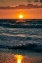 Yellow warm Sun over sea waves at scenic sunset sky, endless sea in warm sunlight at dramatic sunset Royalty Free Stock Photo