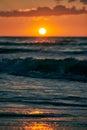 Yellow warm Sun over sea waves at scenic sunset sky, endless sea in warm sunlight at dramatic sunset Royalty Free Stock Photo