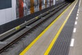 Yellow warning lines on a subway or train station platform. Royalty Free Stock Photo