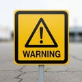 Yellow warning sign with black text and an exclamation mark inside a Royalty Free Stock Photo