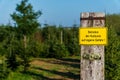 Yellow warning sign with German text `Entering the crops at your own risk`