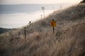 Yellow warning sign next to a mine field, close to the border with Syria, in the Golan Heights, Israel Royalty Free Stock Photo