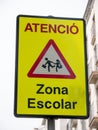 A yellow warning sign "Zona Escolar" in spanish mean "School Zone" in English, Barcelona, spain Royalty Free Stock Photo
