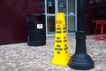 Yellow warning of slip on wet floor cone