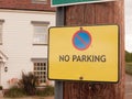 A yellow warning traffic sign outside saying no parking allowed