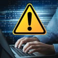 Yellow Warning Triangle Amid Binary Code, Typing Hands Suggest Cybersecurity Theme