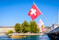 A yellow water bus and Swiss flags in Geneva Royalty Free Stock Photo