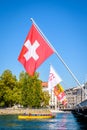 A yellow water bus and Swiss flags in Geneva Royalty Free Stock Photo