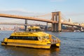 Yellow Water Taxi on the East River in front of the Brooklyn Bridge in New York City Royalty Free Stock Photo