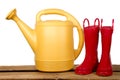 Yellow Watercan and Red Boots Royalty Free Stock Photo