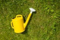 Yellow watering can in the grass. Watering can on the garden. Royalty Free Stock Photo