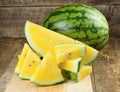 Yellow watermelon sliced on wooden background Royalty Free Stock Photo