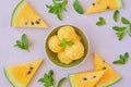 Yellow watermelon sorbet with mint leaves and watermelon slice