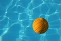 Yellow Waterpolo Ball in blue pool Royalty Free Stock Photo