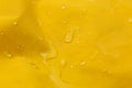 Yellow waterproof fabric with water drops as background, closeup Royalty Free Stock Photo