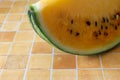 Yellow watremelon isolated on a tile pattern background.