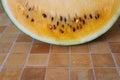 Yellow watremelon isolated on a tile pattern background.