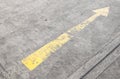 Yellow way arrow pointing symbol on a ground road surface Royalty Free Stock Photo