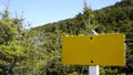 Yellow weathered sign in wooded area