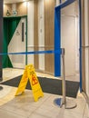 Yellow wet floor caution sign at public toilet area Royalty Free Stock Photo