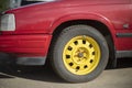 Yellow wheel of car. Red car in parking lot. Transport in city Royalty Free Stock Photo