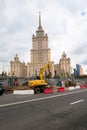 MOSCOW, RUSSIA - OCTOBER 24, 2017: Yellow wheel excavator Hyundai, working in urban environment next to the hotel `Ukraine`.