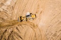 Yellow wheel loader working in construction site. aerial drone image Royalty Free Stock Photo