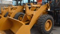 Yellow wheel loaders standing in a row