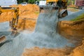 Yellow wheel unloading gravel at construction work equipment machinery for construction of foundation Royalty Free Stock Photo