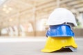 Yellow,white,blue hard safety wear helmet hat in the project at construction site Royalty Free Stock Photo