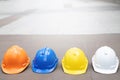 Yellow,white,blue hard safety wear helmet hat in the project at construction site