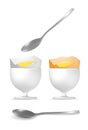 Yellow and white boiled eggs with spoon and egg cups