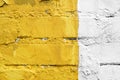 Yellow and white brick wall detail texture background. Old, painted, weathered and cracked bricks with concrete and stucco Royalty Free Stock Photo