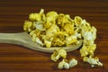 Yellow white butter popcorn on wooden spoon Royalty Free Stock Photo