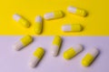 Yellow-white capsules of celibacy on a yellow-white background. Medical background.