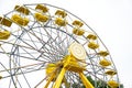 Yellow and white Ferris wheel with many seats Royalty Free Stock Photo