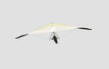 Yellow and white hang glider in flight off,isolated on light grey Royalty Free Stock Photo