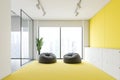 Yellow and white office lounge with pouffes Royalty Free Stock Photo