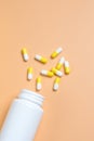 Yellow and white pills, tablets and white bottle Royalty Free Stock Photo