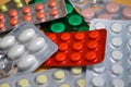 Yellow, white, red, green round and oval medical tablets in pack, tablets packed in blisters macro