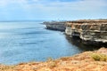 Yellow, white rocky seashore, Chalky cliff. Blue deep calm sea. Royalty Free Stock Photo