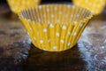Yellow and white spotted cupcake case