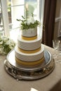 Yellow and white three tiered cake
