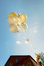 Yellow and white transparent balloons blue sky with children hands