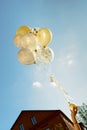 Yellow and white transparent balloons blue sky with children hands Royalty Free Stock Photo