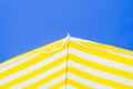 Yellow and white umbrellas with the blue sky in the background, symbols of summer Royalty Free Stock Photo