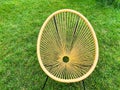 Yellow wicker egg chair on green lawn in summer garden top view Royalty Free Stock Photo