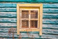 Yellow window in old turquoise wooden house Royalty Free Stock Photo