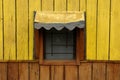 Yellow window of a wooden cottage